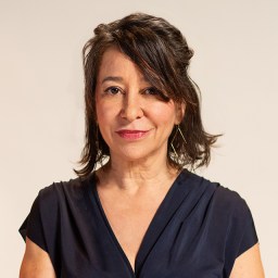 A woman in a blue dress posing for a photo.