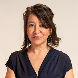 A woman in a blue dress posing for a photo.