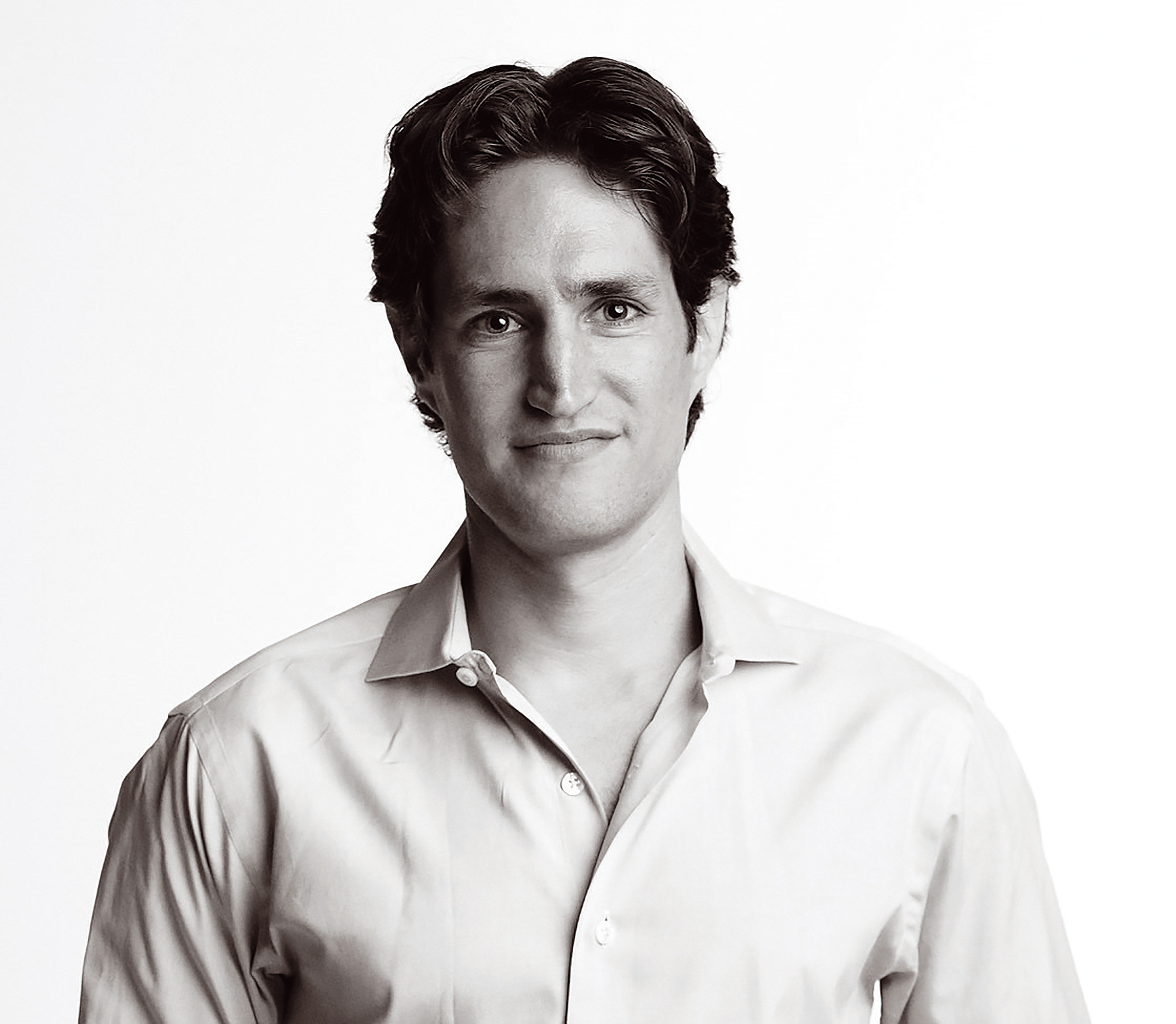 a black and white photo of a man in a dress shirt.