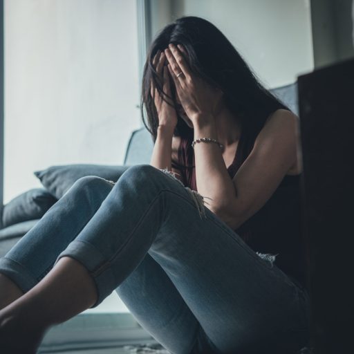 A woman suffers a panic attack alone.