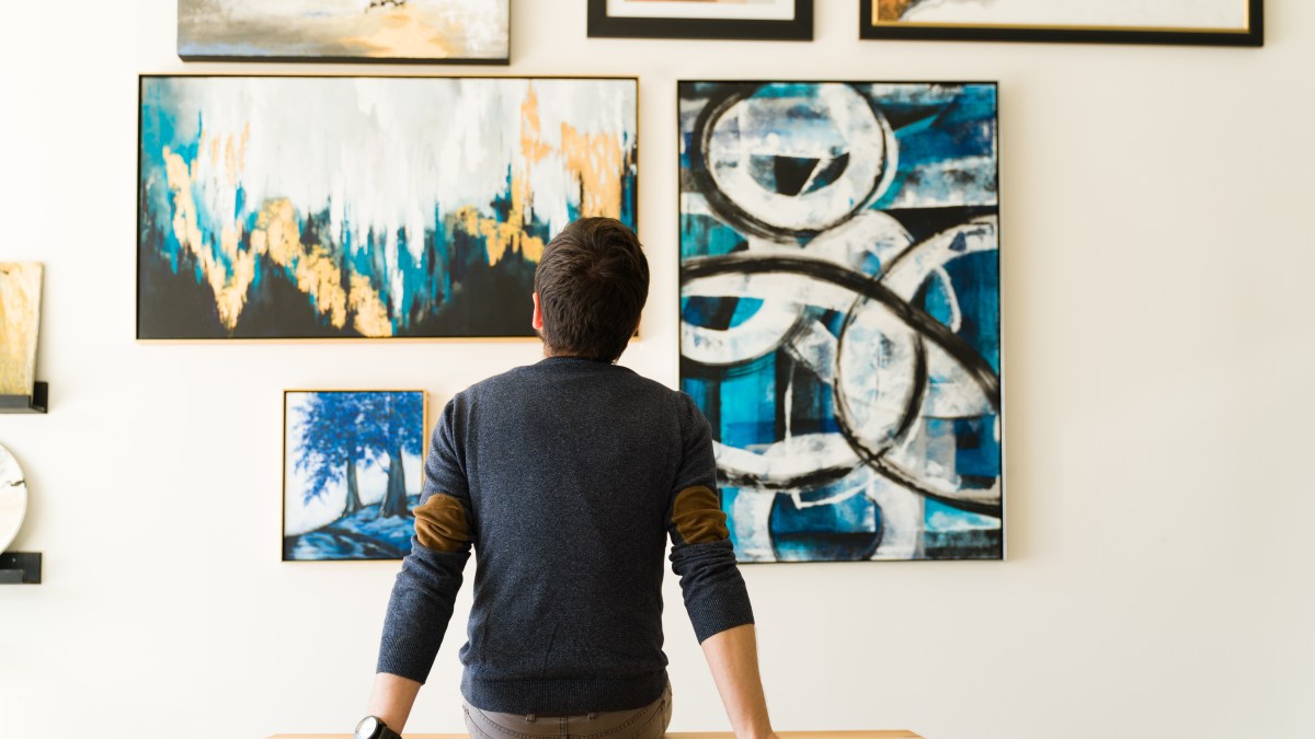 Rear view of a guy looking at an art exhibition.