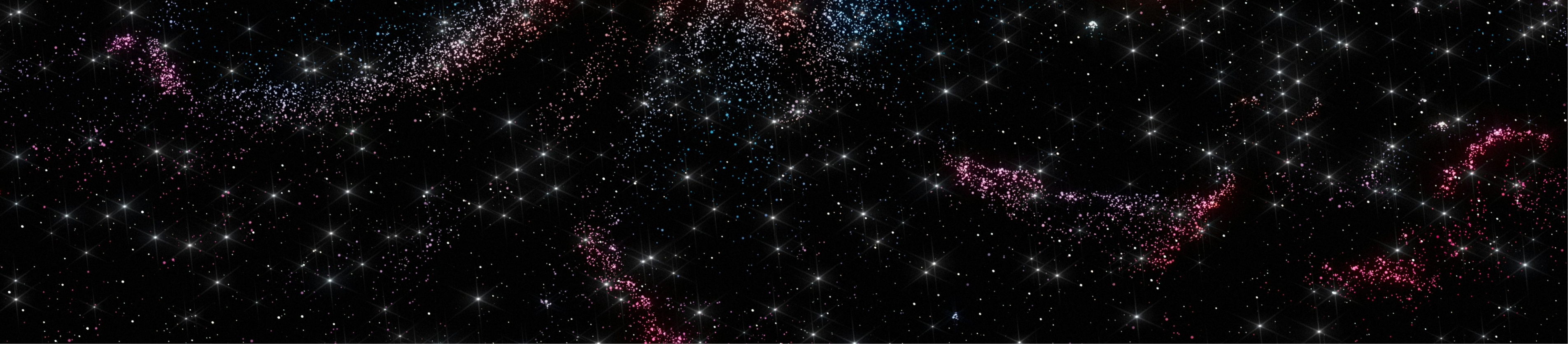 A field of stars and colorful cosmic dust clouds scattered across the dark expanse of space.