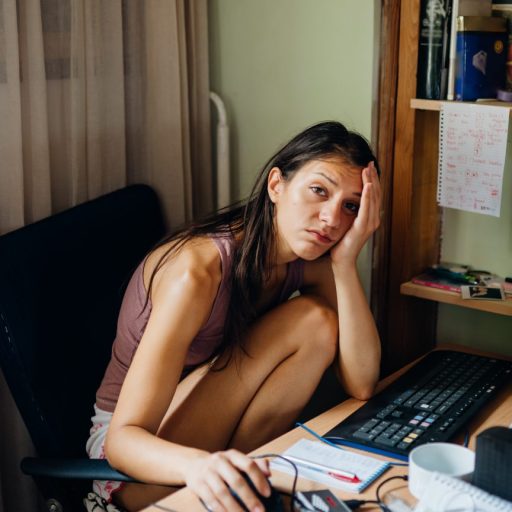 Stressed, depressed student working from her computer during the coronavirus pandemic.