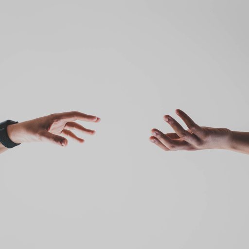 Holograms you can touch illustrated by two hands reaching toward each other.