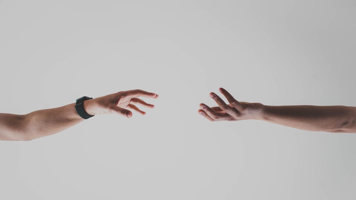 Holograms you can touch illustrated by two hands reaching toward each other.