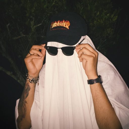 A man in a ghost costume showing why Halloween is so popular for adults.