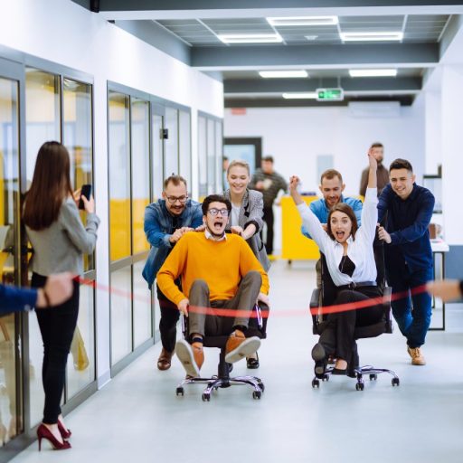 Office team plays a game of chair races to keep their spirits up.
