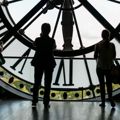 Three people standing on the inside of a clock illustrating an article on daylight saving time.