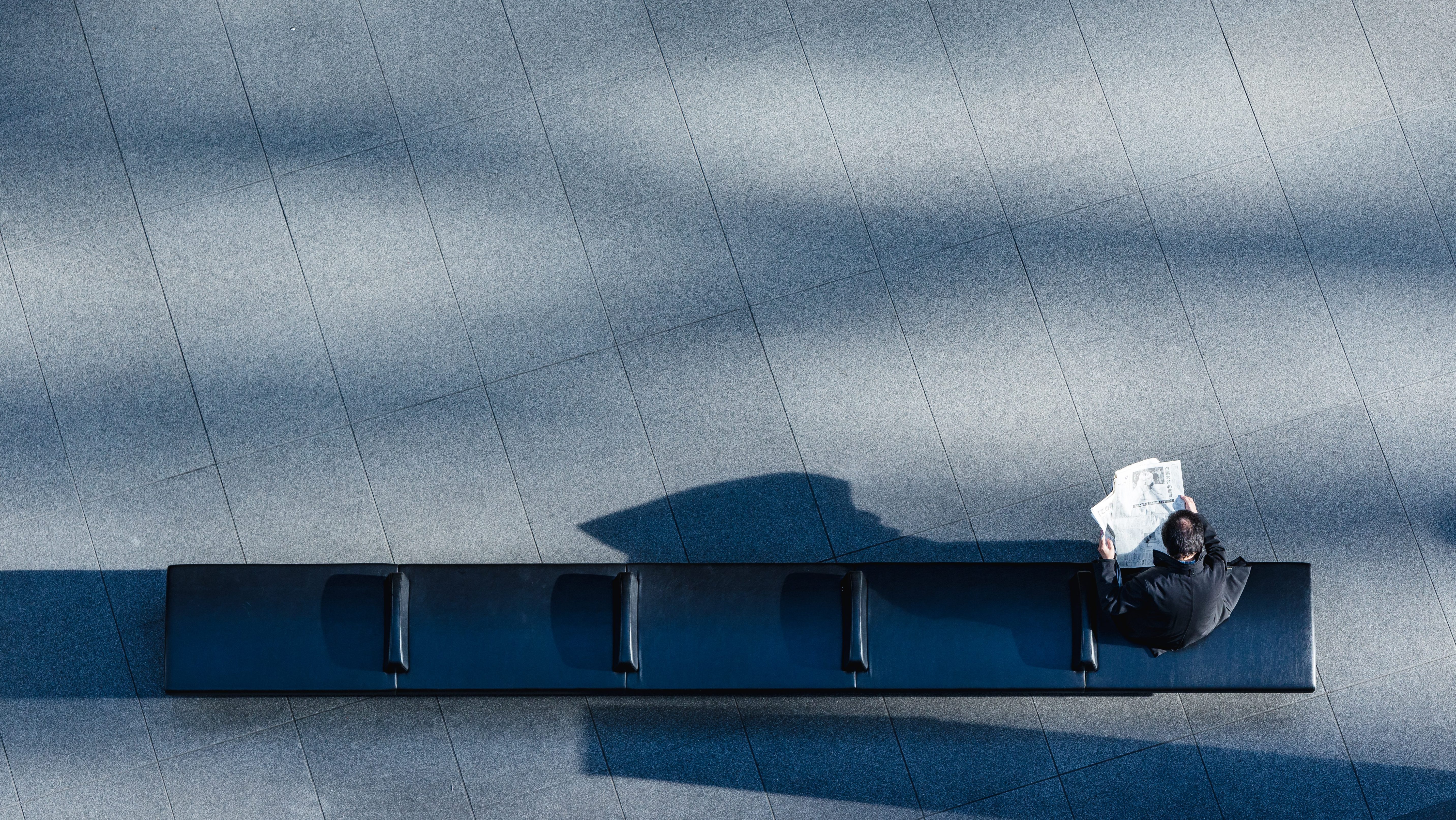 A man sitting alone on a bench illustrating the worker shortage