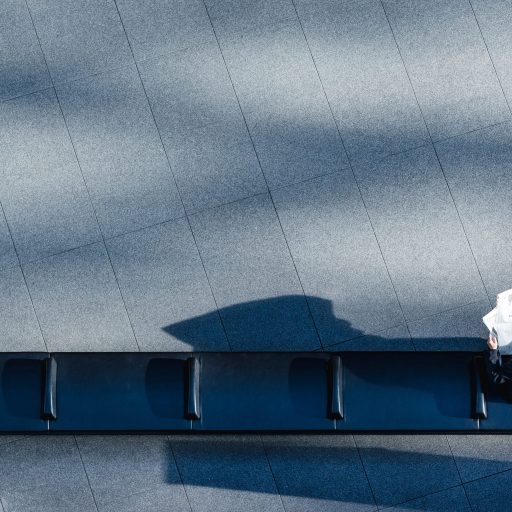 A man sitting alone on a bench illustrating the worker shortage
