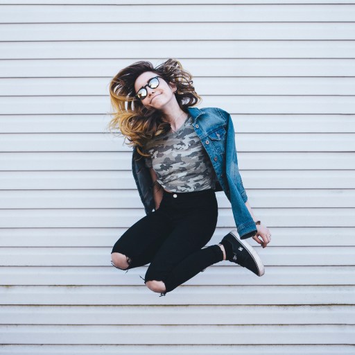 A woman jumping for joy illustrating toxic positivity