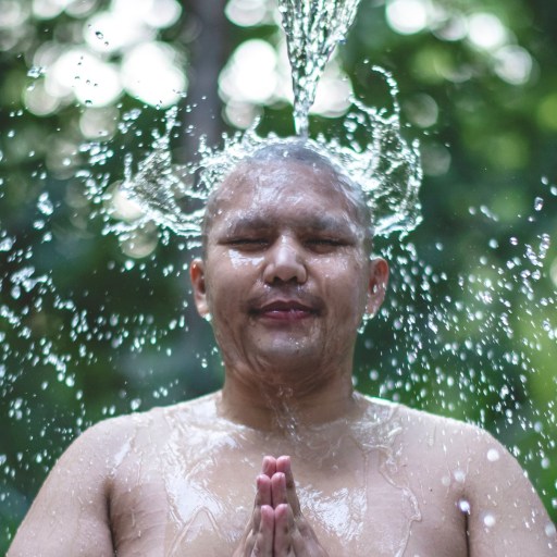A man having a cold outdoor shower.