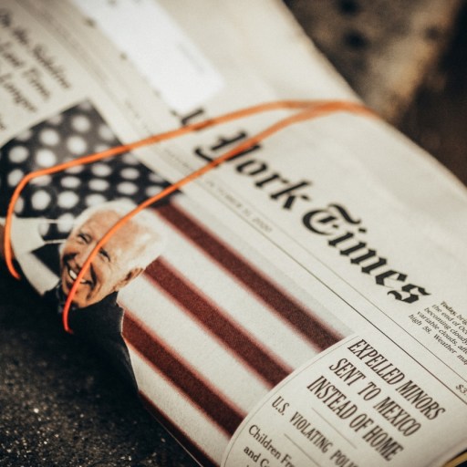 A rolled up newspaper with Joe Biden on the front page.