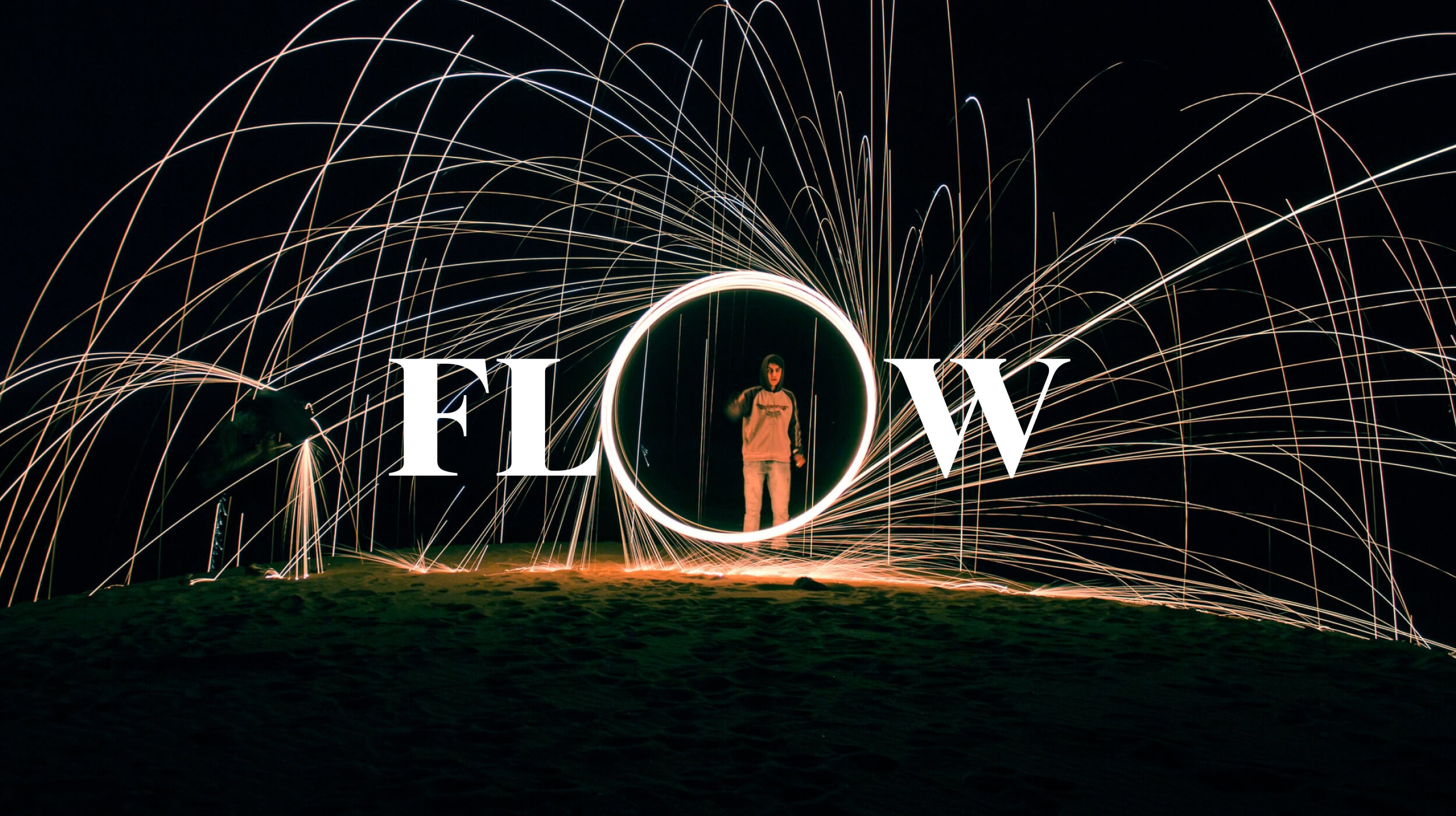 A person stands inside a glowing circle with sparks flying around in arcs, capturing the essence of "What is flow state," as the word "FLOW" appears in bold white letters across the center.