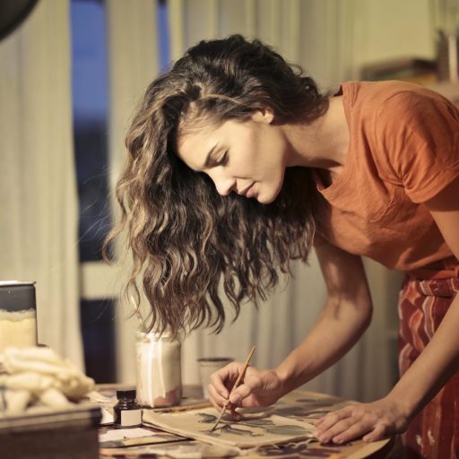 A woman paints as part of her creative habit.