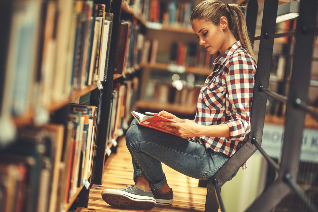 A student reads in her college library.
