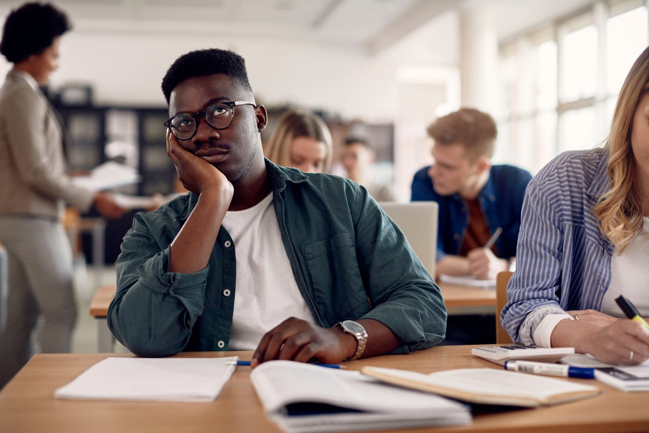 A college student's mind wanders as he listens to a boring lecture.