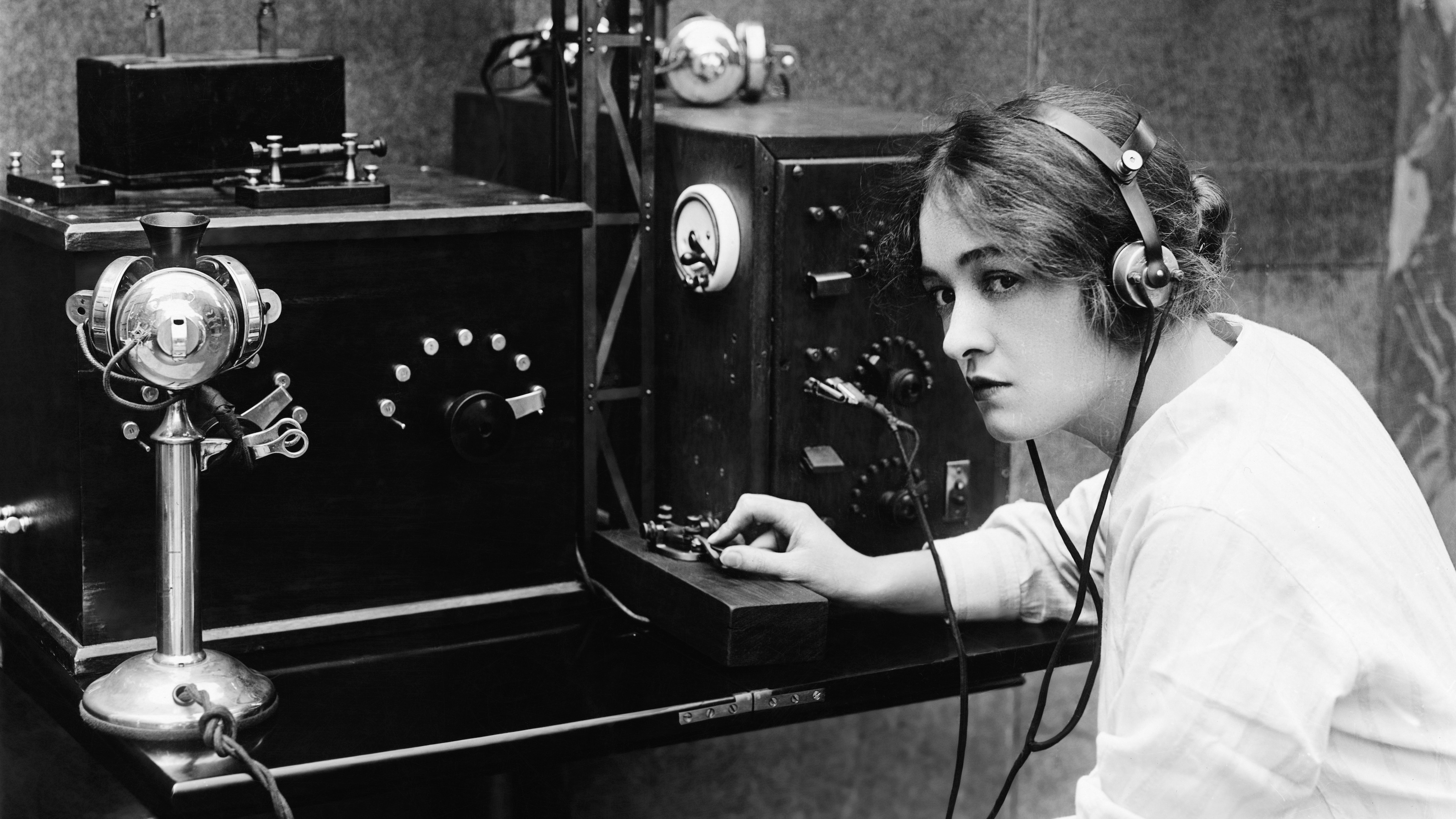 Woman sending Morse code using telegraph