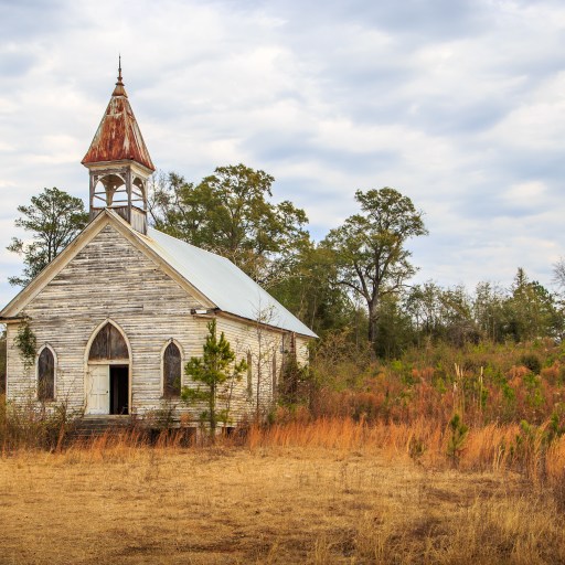 An abandoned church in a field