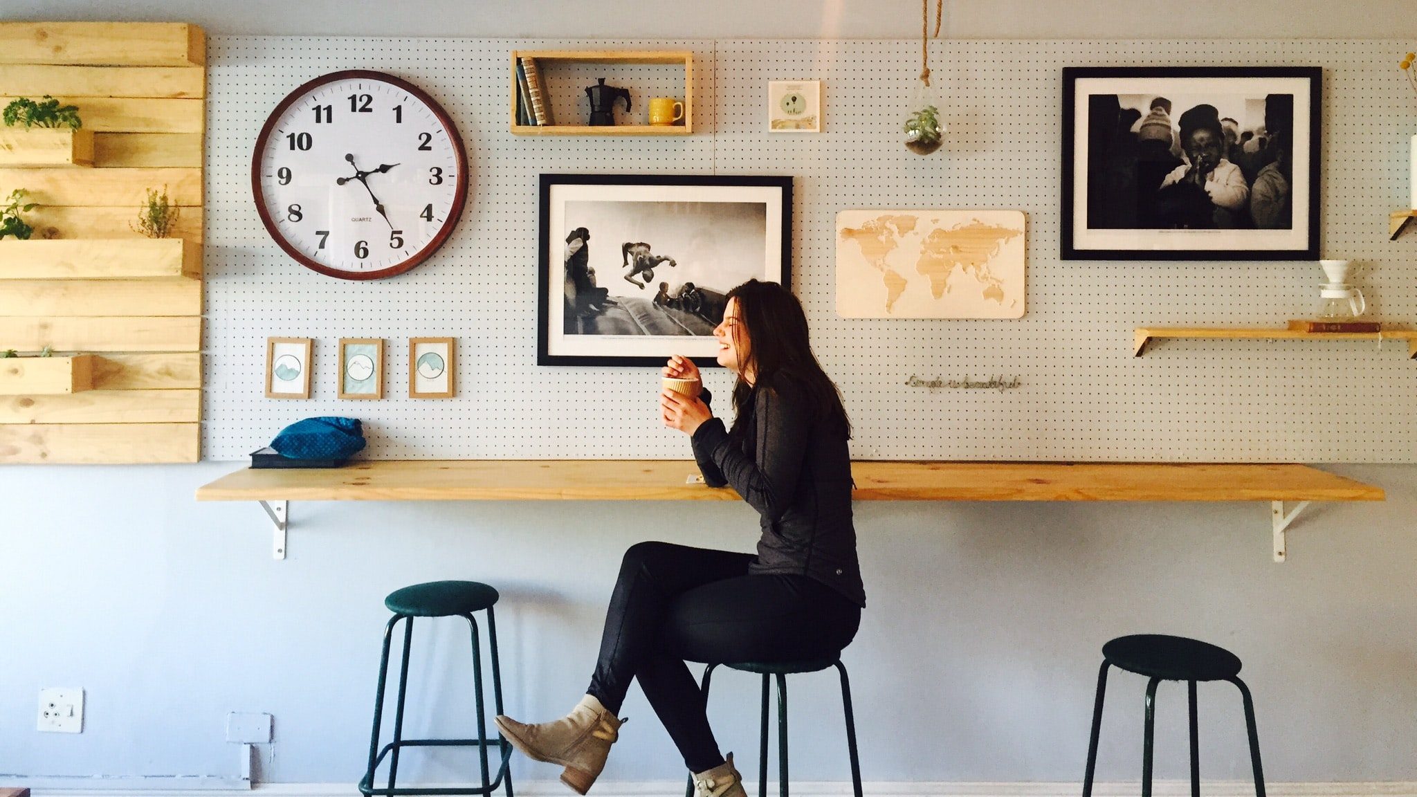 A woman enjoys a drink in a cafe.