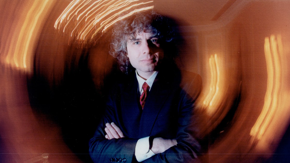 A man in a suit with crossed arms.