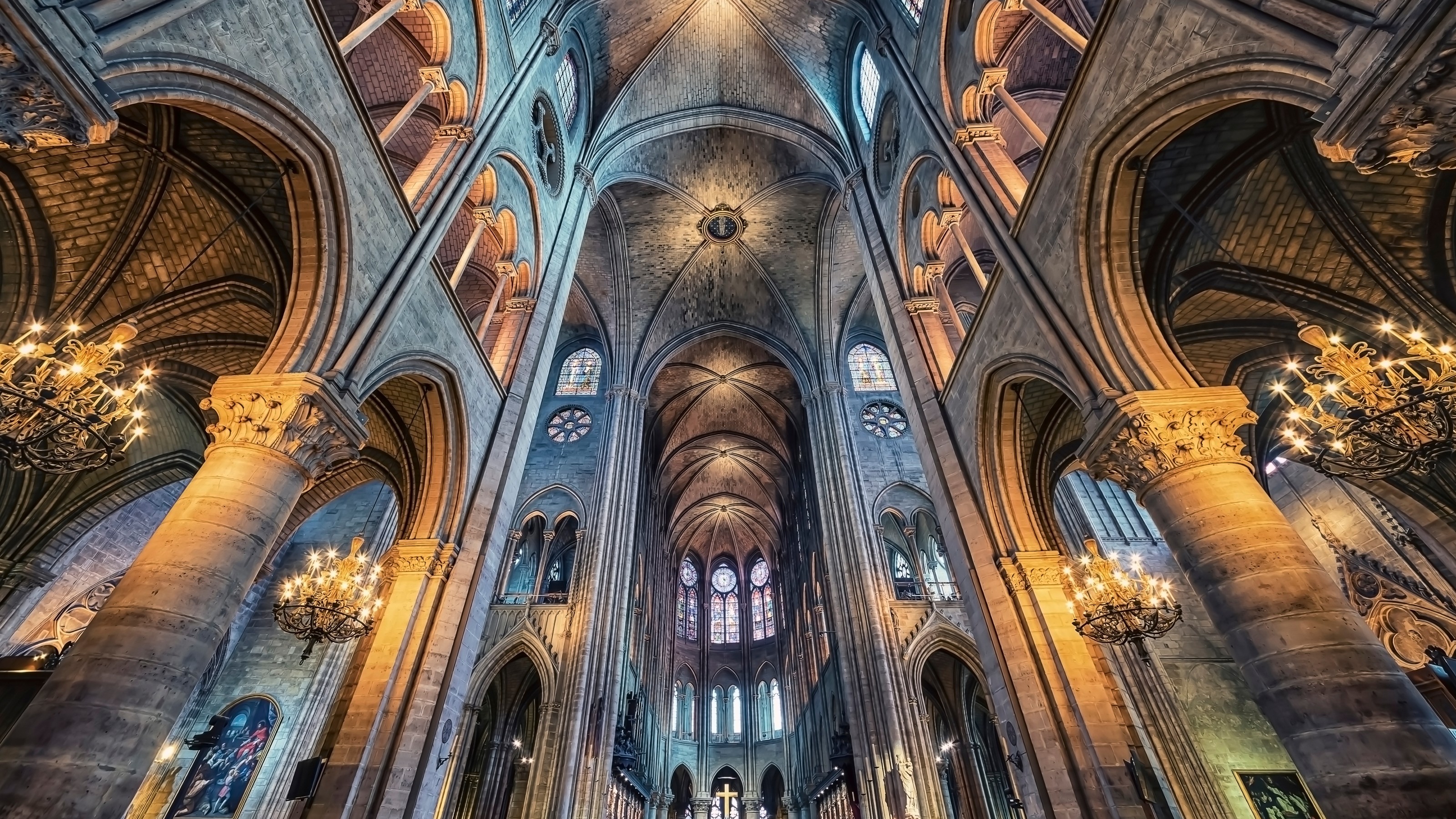 the interior of a large cathedral with chandeliers.
