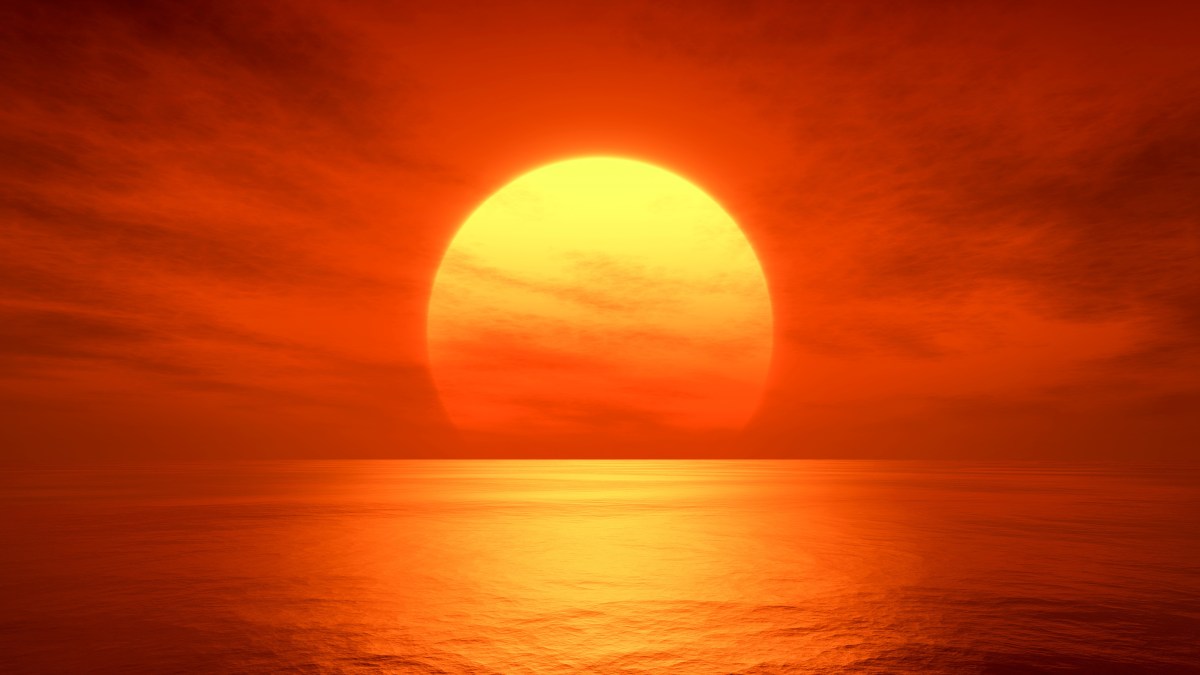 the sun is setting over the ocean on a cloudy day.