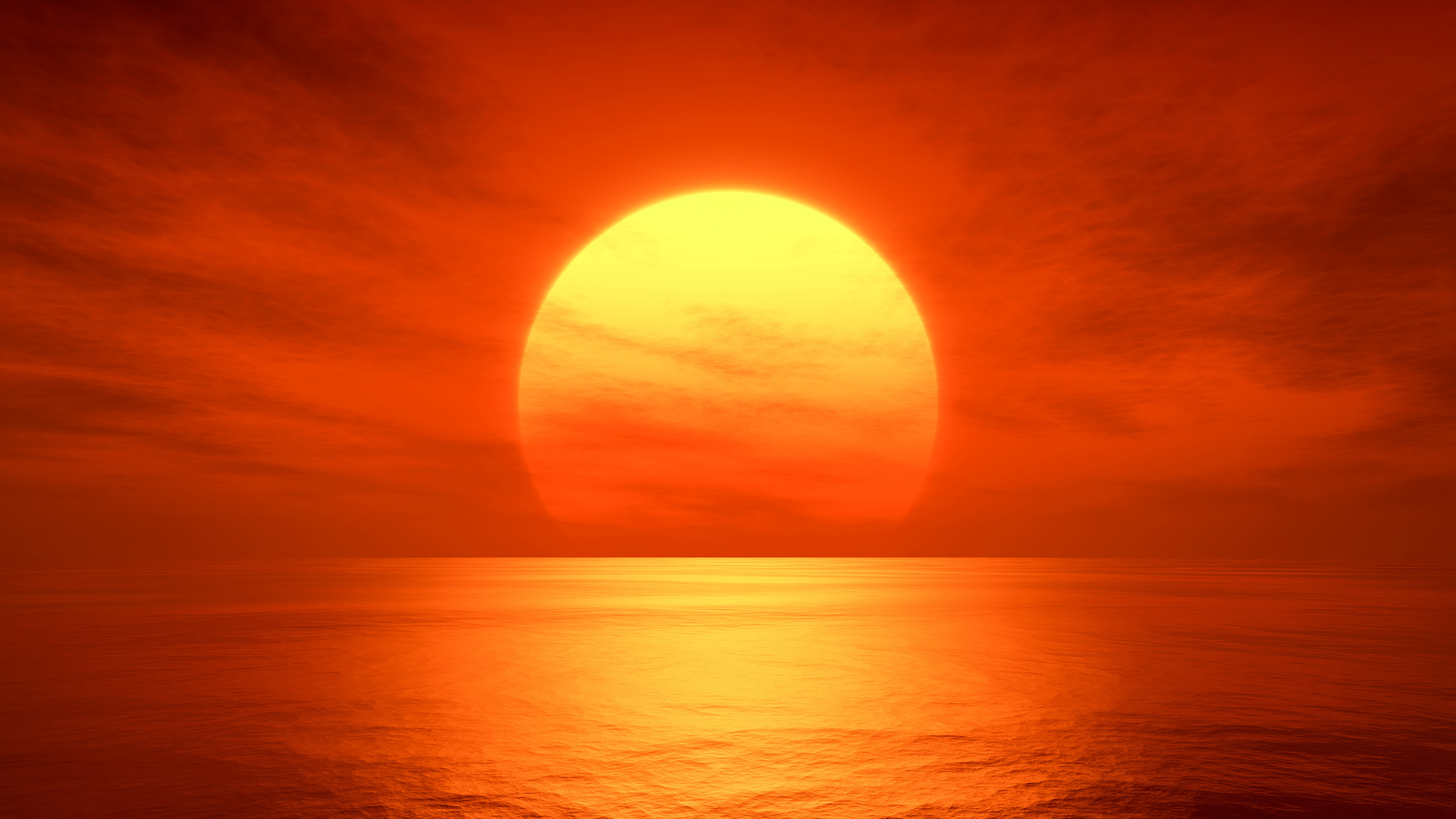 the sun is setting over the ocean on a cloudy day.