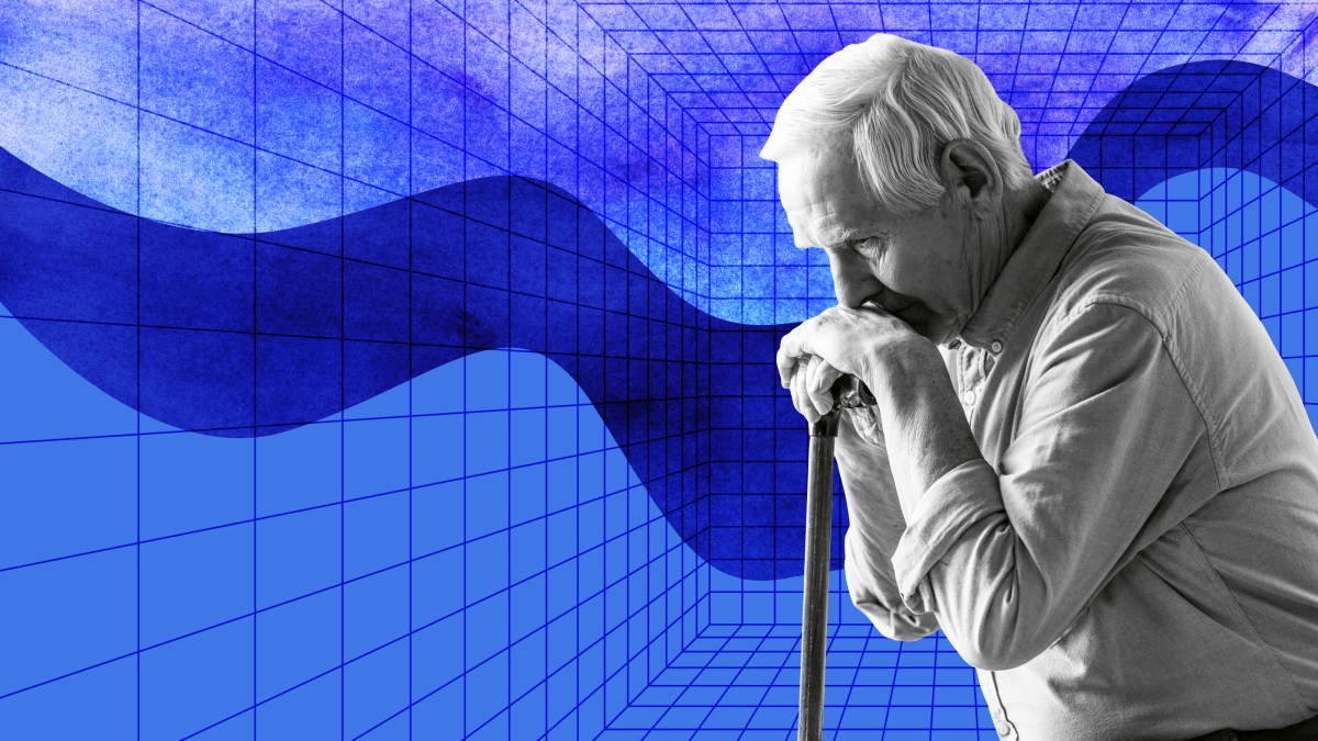 a man holding a microphone in front of a blue background.