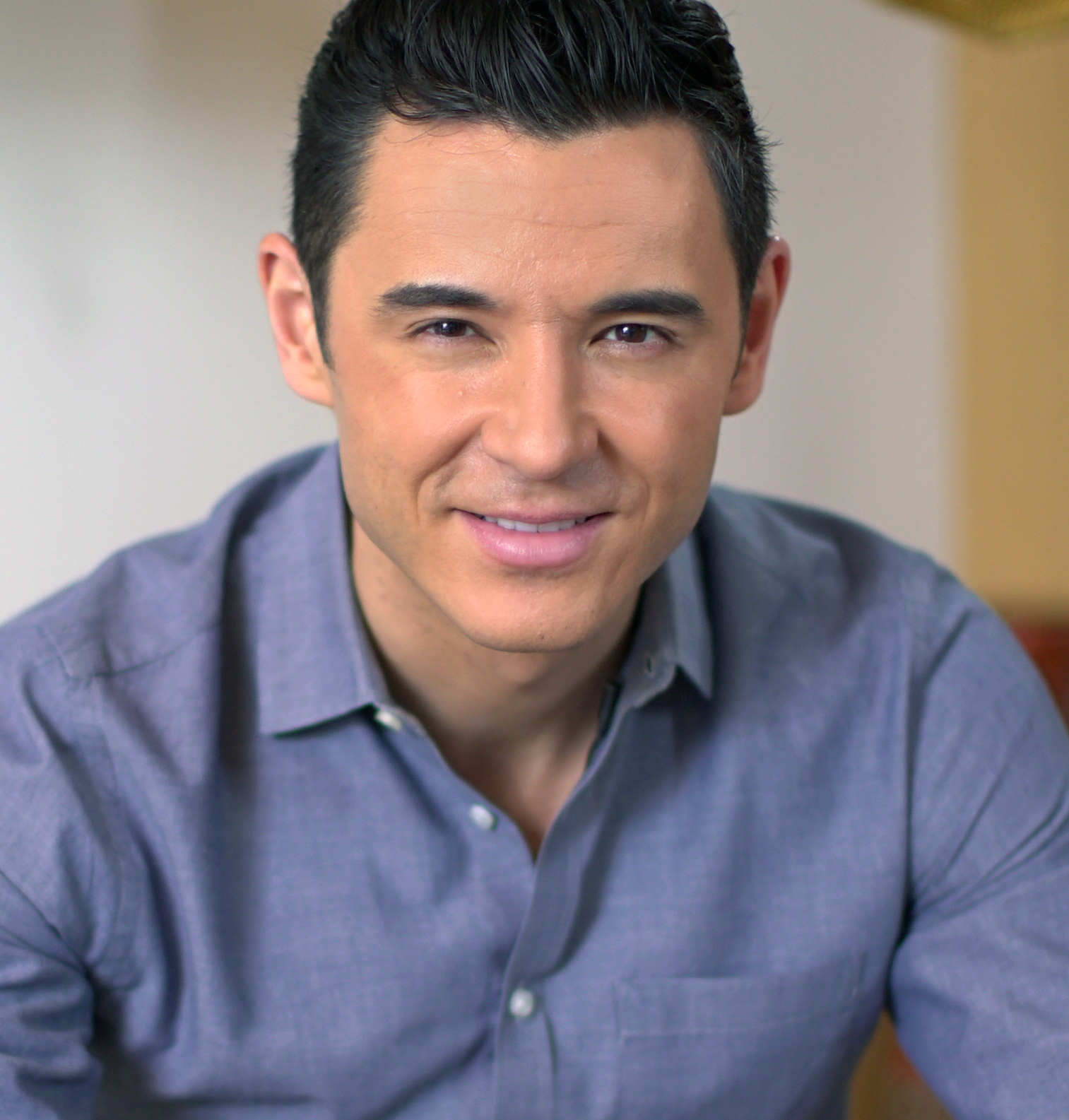 a man in a blue shirt is posing for a picture.