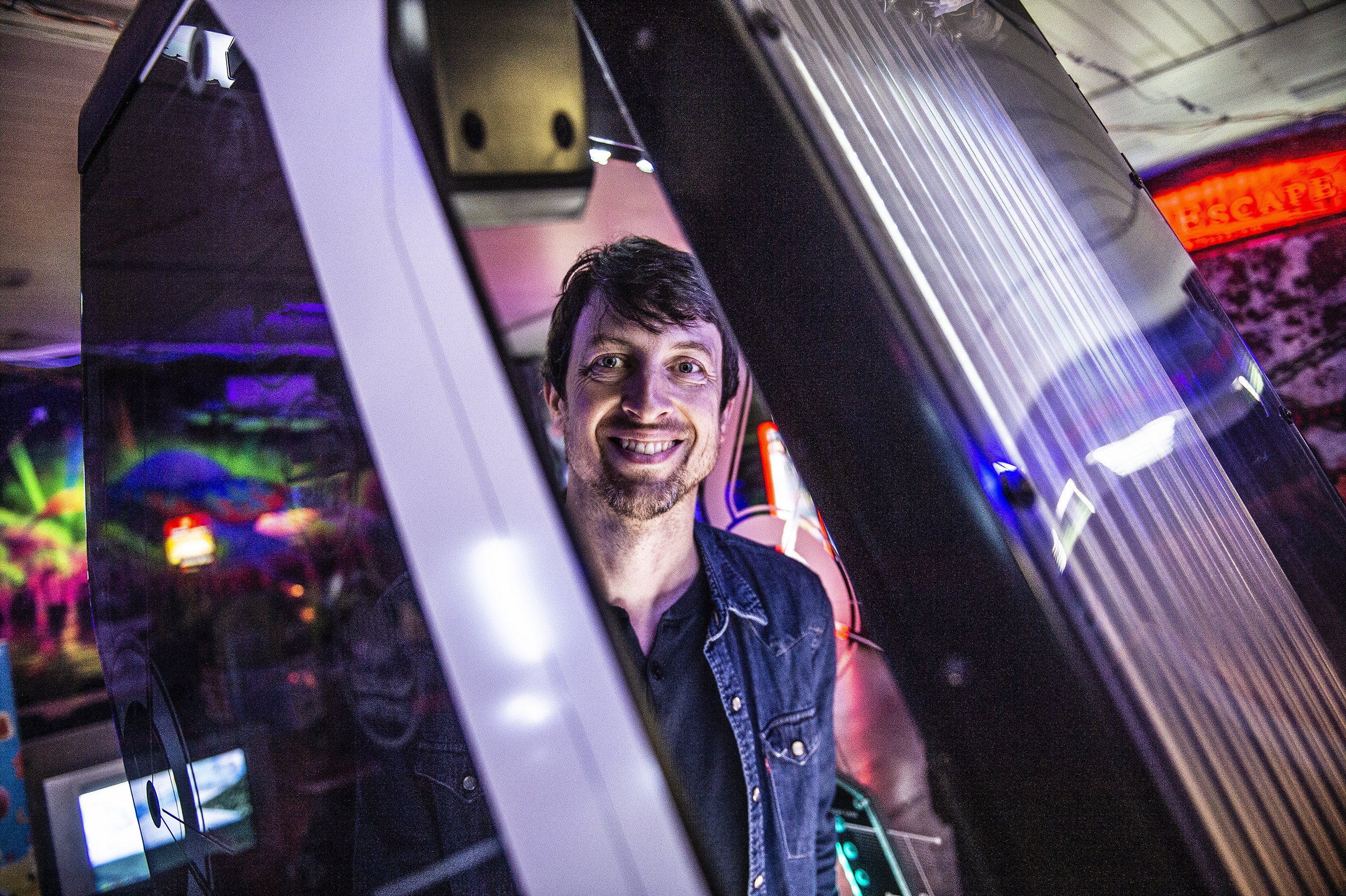 Jaroslav Švelch standing in an arcade.