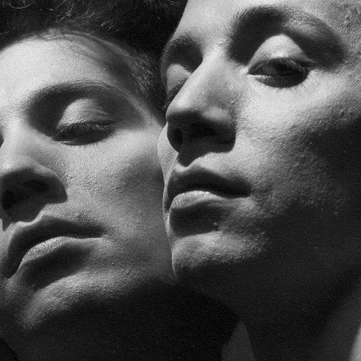 A black and white photo featuring two men engaged in a profound gaze.