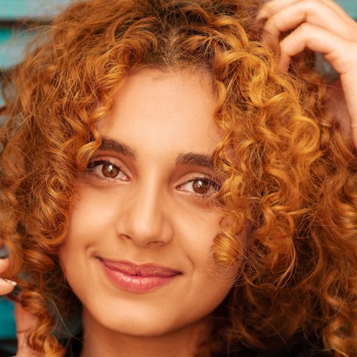 a close up of a person with curly hair.