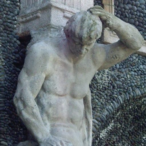 a statue of a man scratching his head