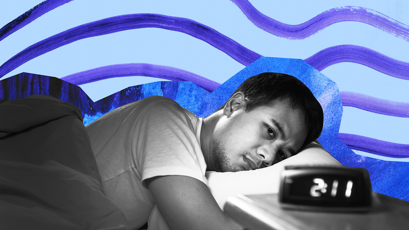 a man sleeping in a bed with a clock.