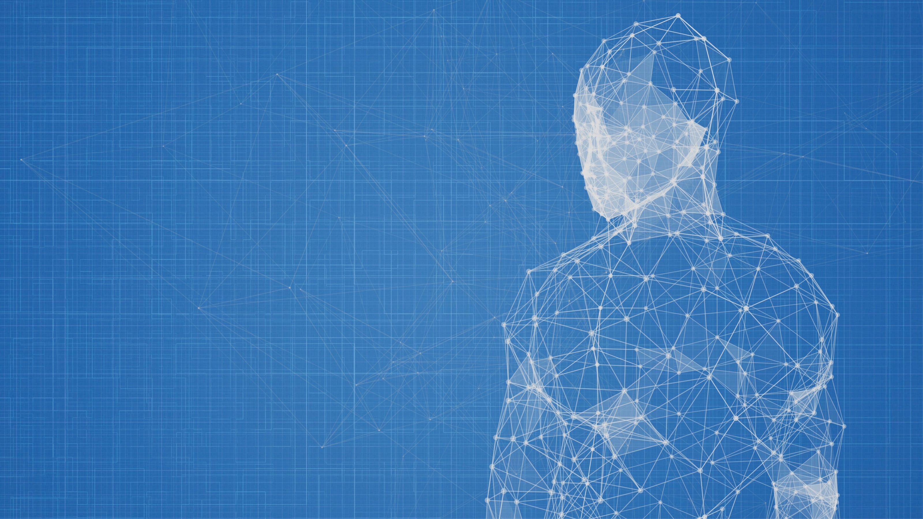 a person standing in front of a blue background.