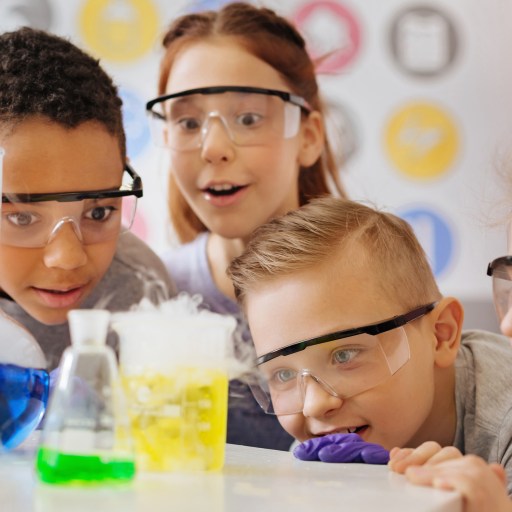 a group of kids wearing glasses in a lab.
