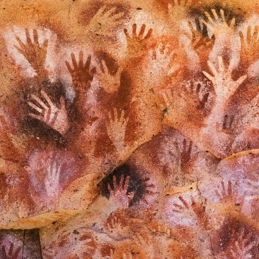 a group of hand prints on a rock.