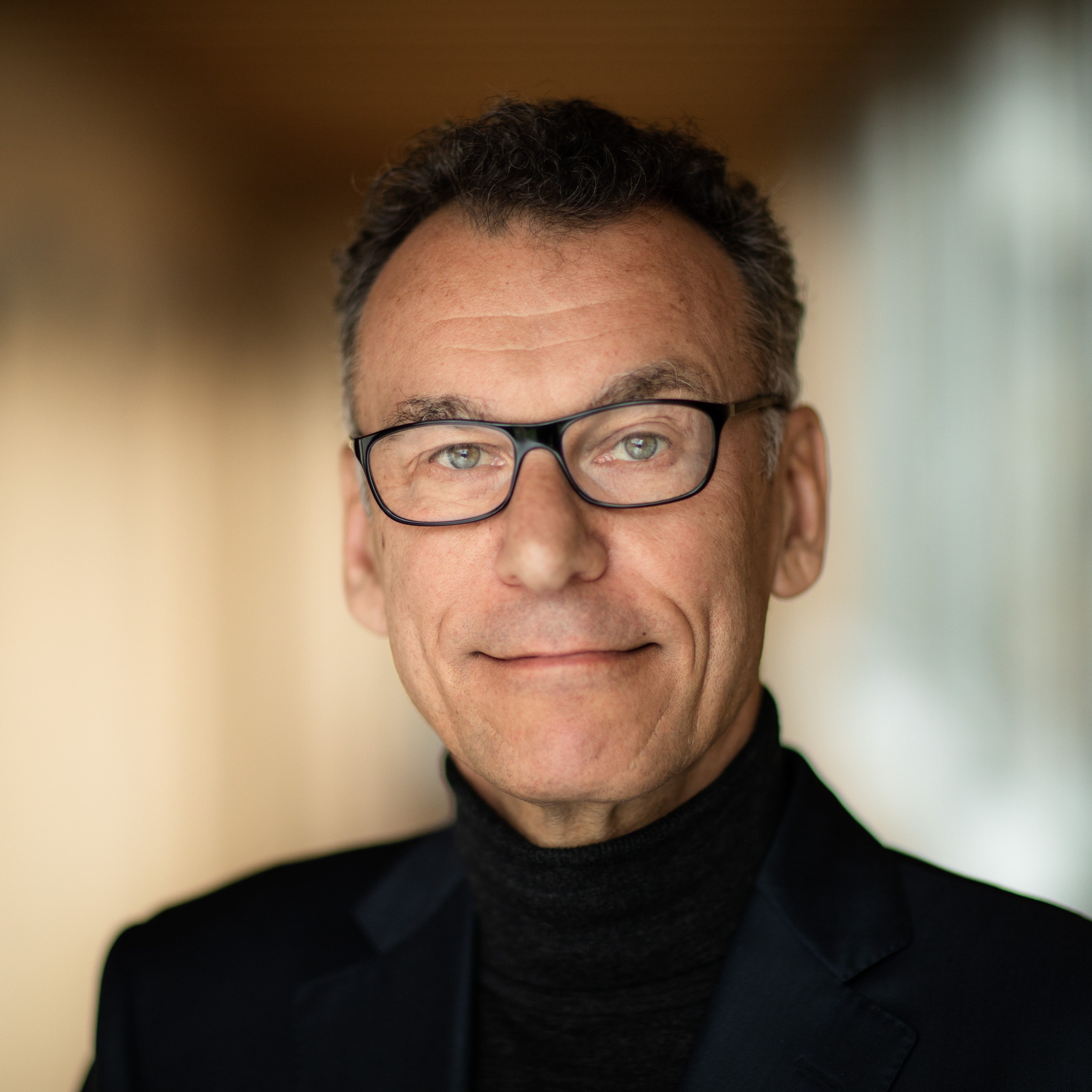 a close up of a person wearing glasses.