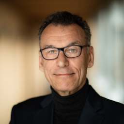 a close up of a person wearing glasses.