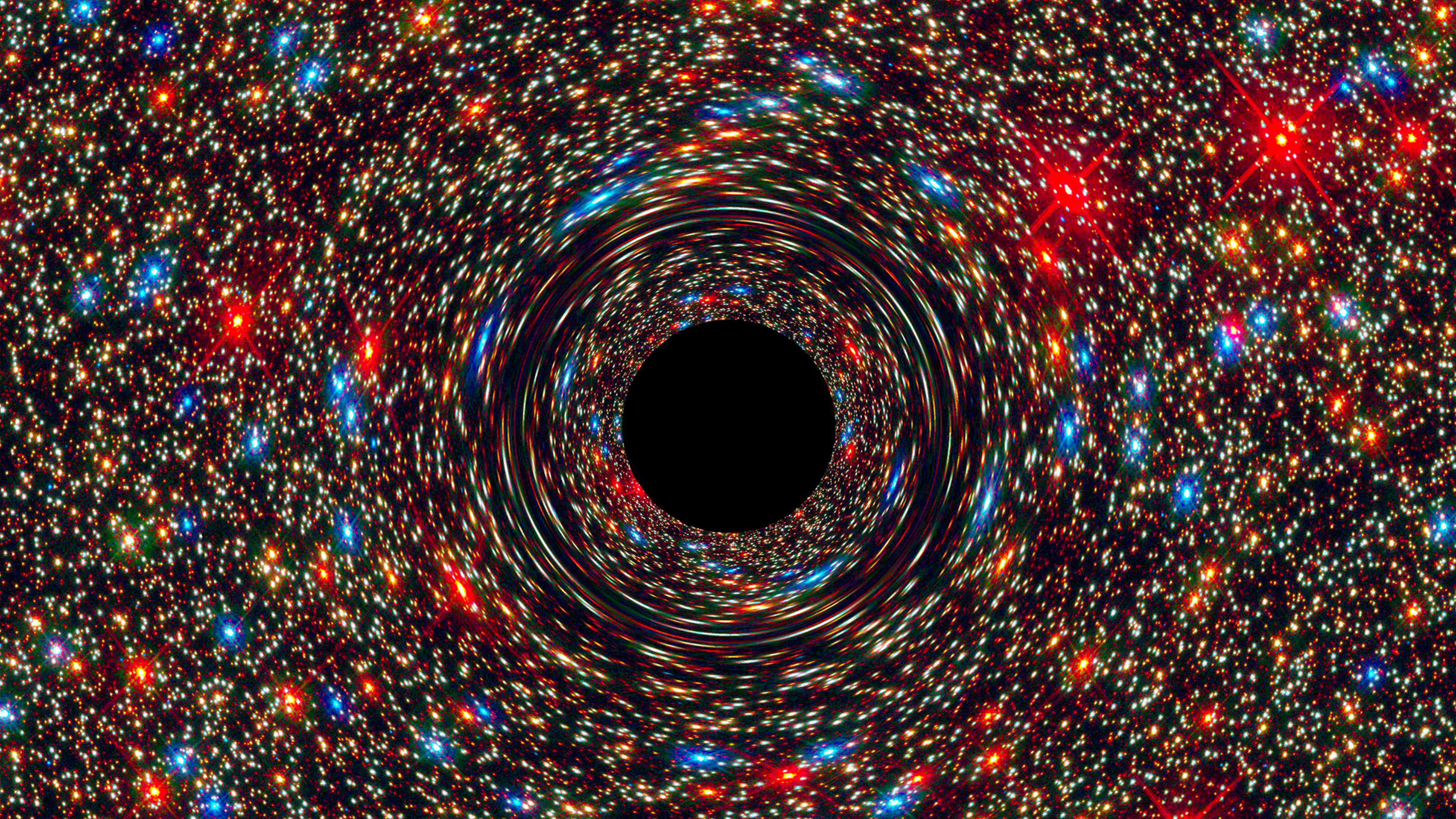 a black hole in the center of a space filled with stars.