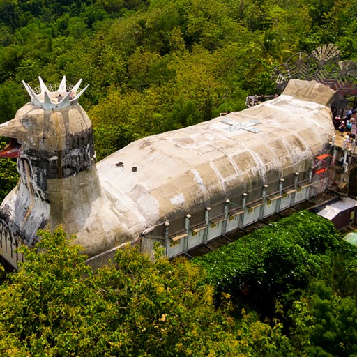 a large building in the middle of a forest.