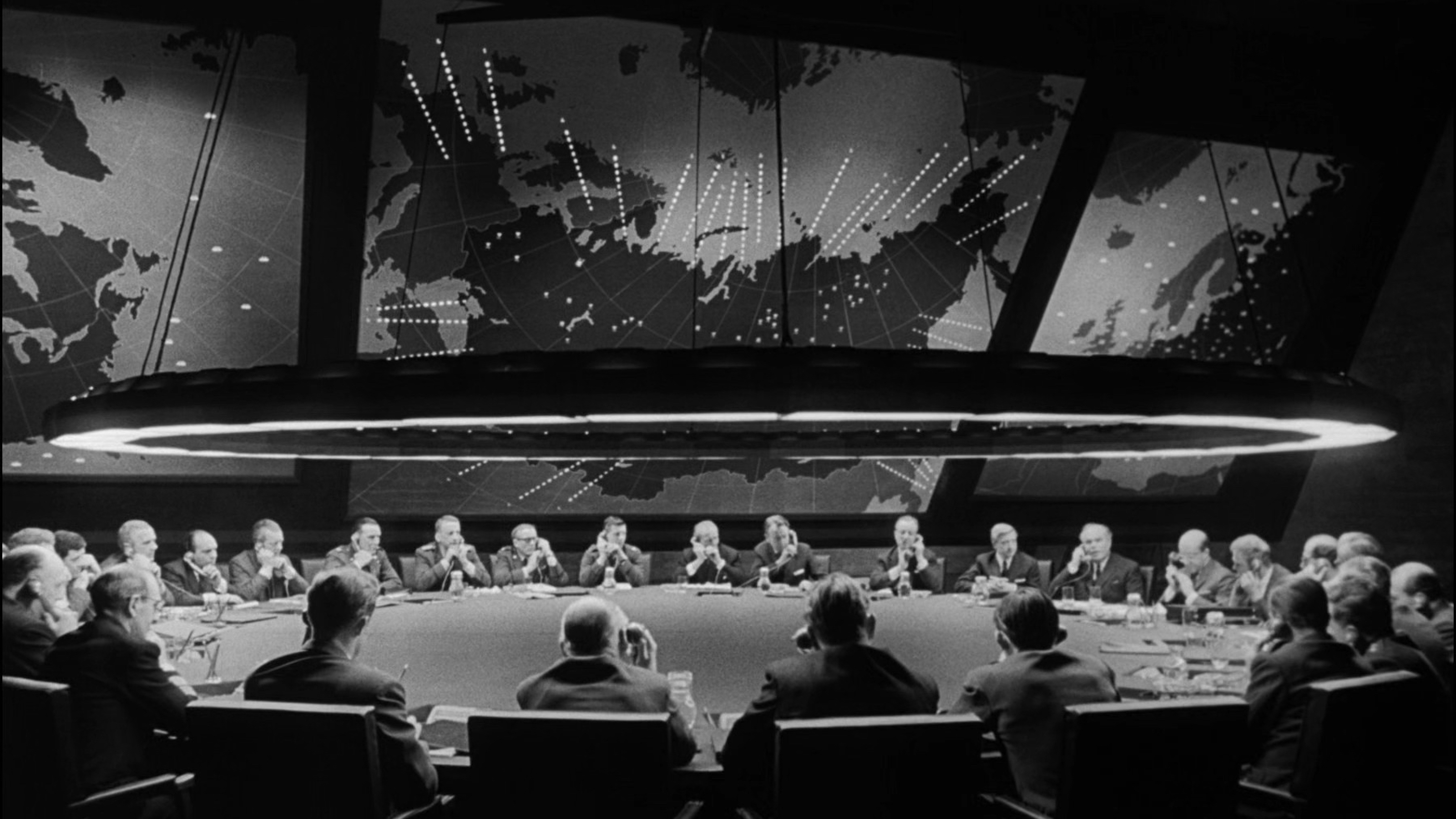 a group of people sitting around a conference table.