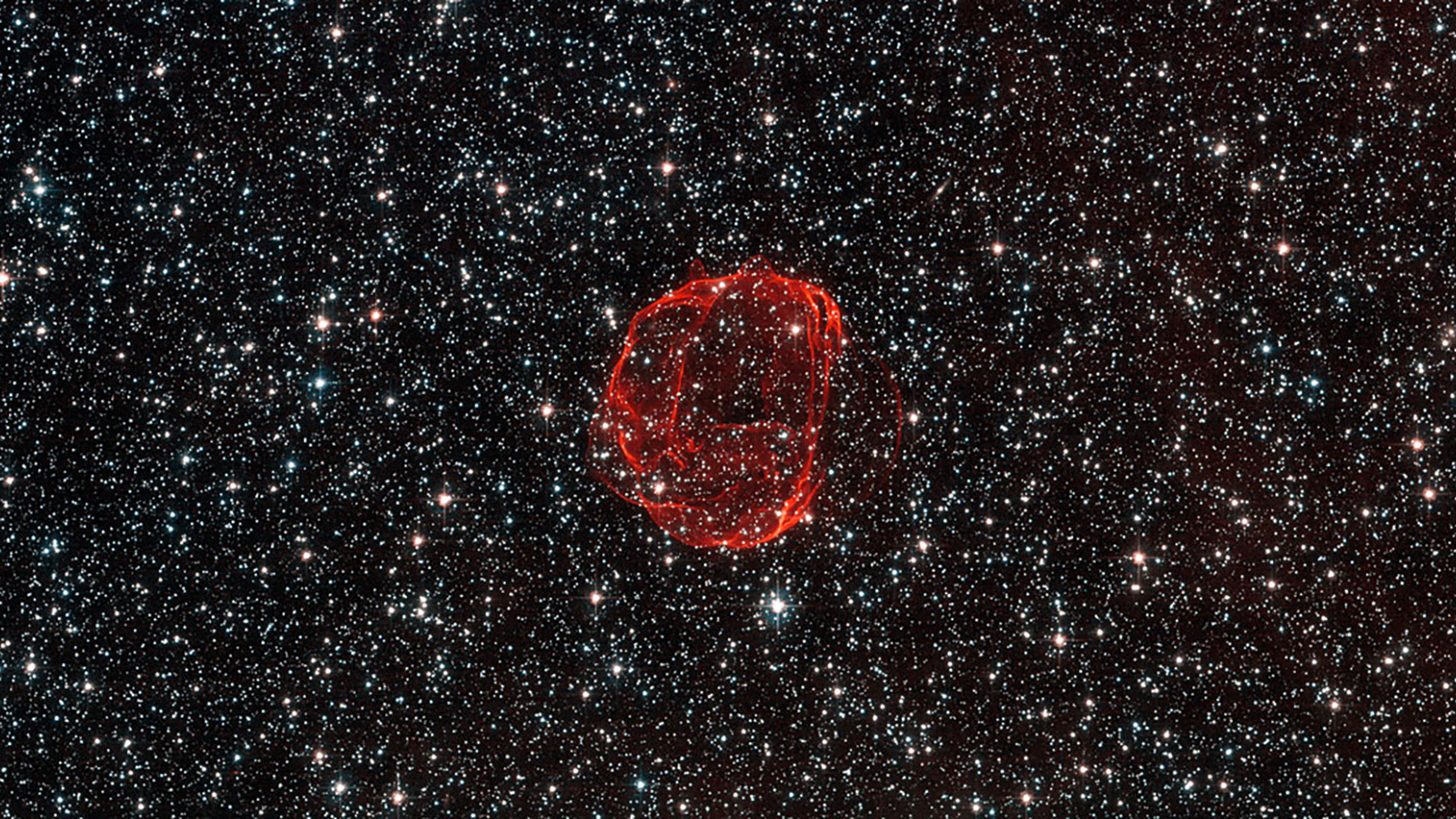 a red object in the middle of the night sky.