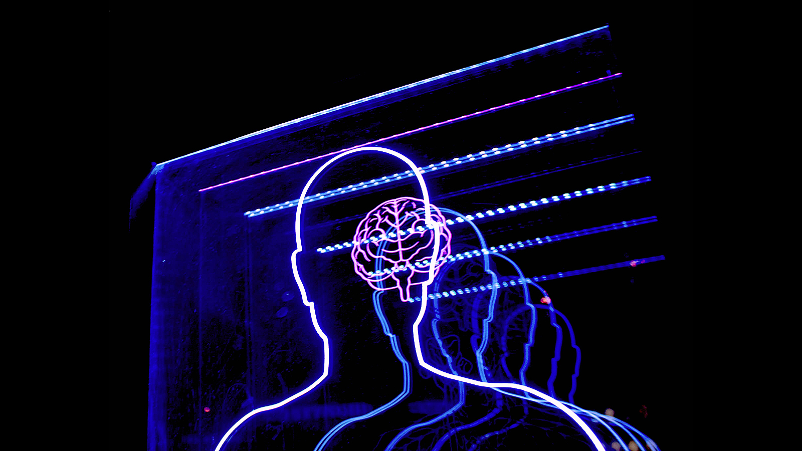 a man's head is projected in blue light.