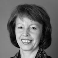 a black and white photo of a smiling woman.