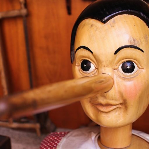 a wooden dummy with a wooden stick sticking out of it's mouth.