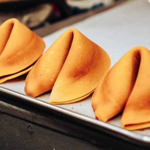 a metal tray topped with four pieces of food.