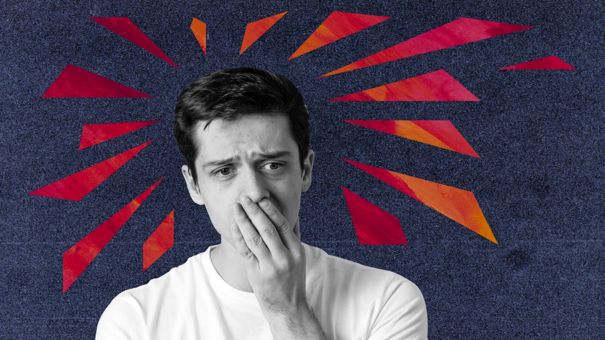 a man covers his mouth with his hands.