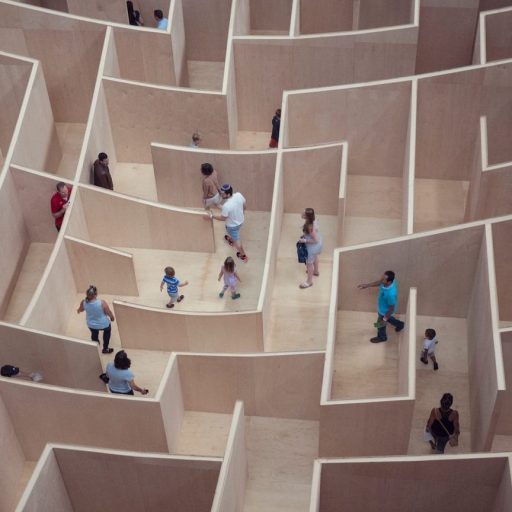 a group of people standing inside of a maze.
